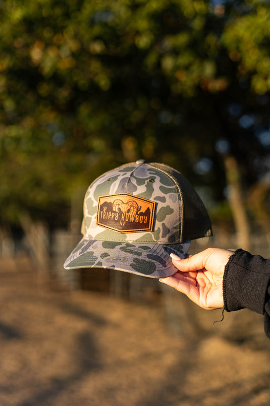 Trippy Kowboy leather patch Camo trucker hat